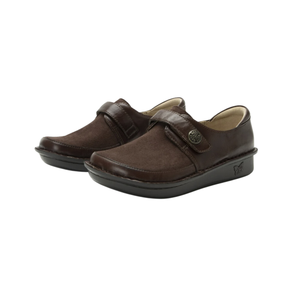Alegria Women’s Brenna Slip-On in Choco Luster side view showcasing a premium oiled leather upper, supportive slip-on silhouette with dual elastic gores, mild rocker outsole, and slip-resistant rubber bottom designed for all-day comfort, stability, and professional wear.
