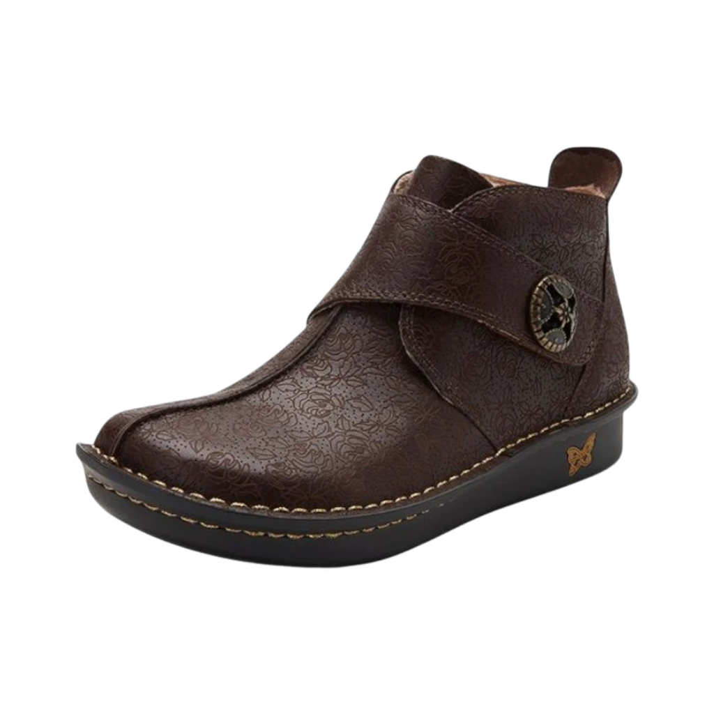 Alegria Women’s Caiti ankle boot in Cocoa Impression side view showcasing a premium leather upper, adjustable hook-and-loop strap, supportive ankle-height silhouette, and mild rocker slip-resistant outsole designed for stability, comfort, and all-day wear.
