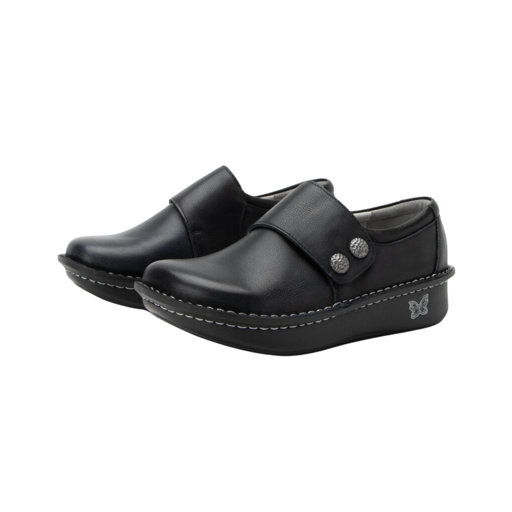 Alegria Women’s Deliah Slip-On Shoe in Upgrade Black side view showcasing the smooth leather upper, double elastic side gores, padded heel collar, mild rocker bottom, and slip-resistant outsole designed for professional style and all-day comfort.