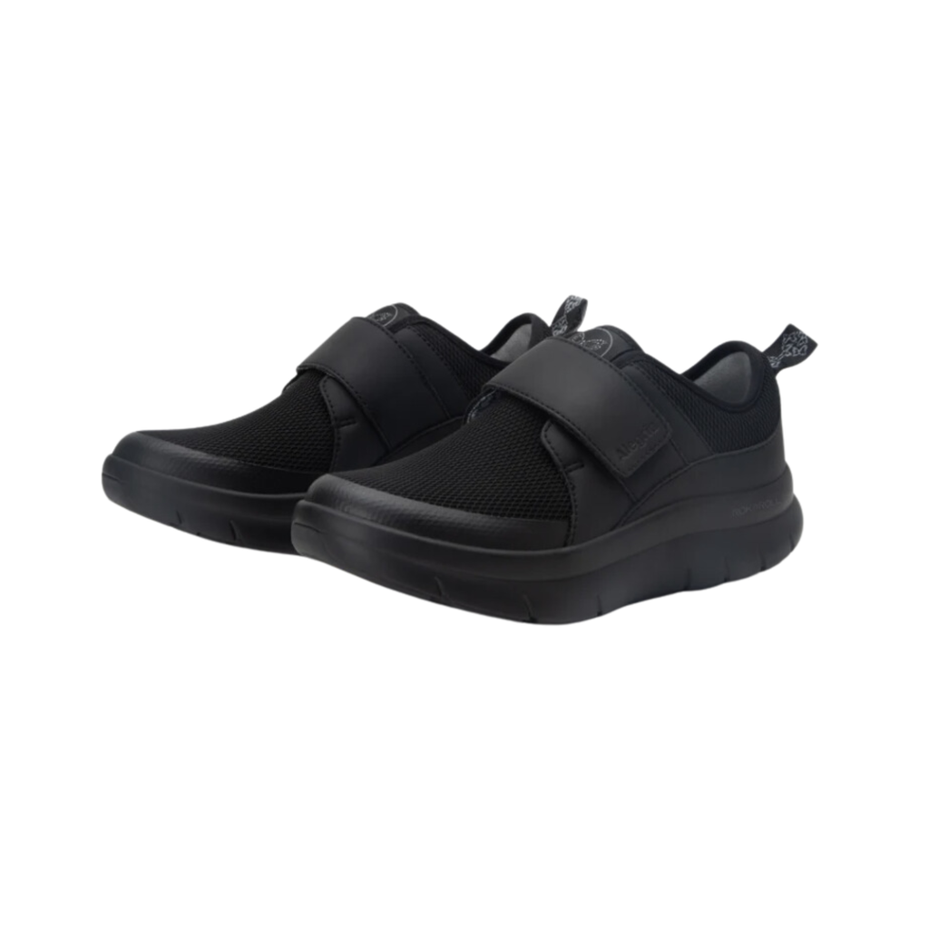 Alegria Women’s Double Trouble Slip-On in Black Mesh side view showcasing the breathable mesh upper, dual elastic gores, low-profile athleisure design, lightweight flexible outsole, and supportive Alegria comfort technology for all-day wear.