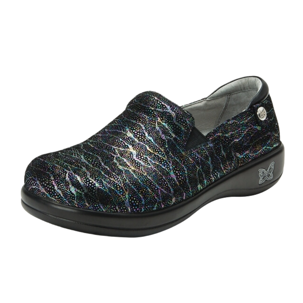 Alegria Women’s Keli Slip-On Shoe in Dermatic side view showcasing the stain-resistant leather upper with a rich brown luster finish, professional slip-on silhouette, padded collar, mild rocker sole, and slip-resistant outsole designed for lasting comfort and workplace stability.