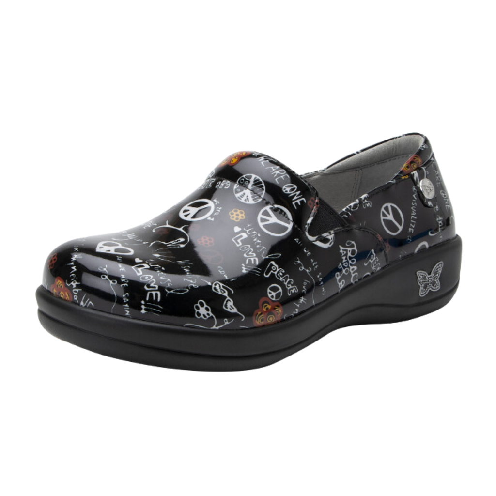 Alegria Women’s Keli Slip-On Shoe in Peace and Love side view showcasing the stain-resistant leather upper with a rich brown luster finish, professional slip-on silhouette, padded collar, mild rocker sole, and slip-resistant outsole designed for lasting comfort and workplace stability.