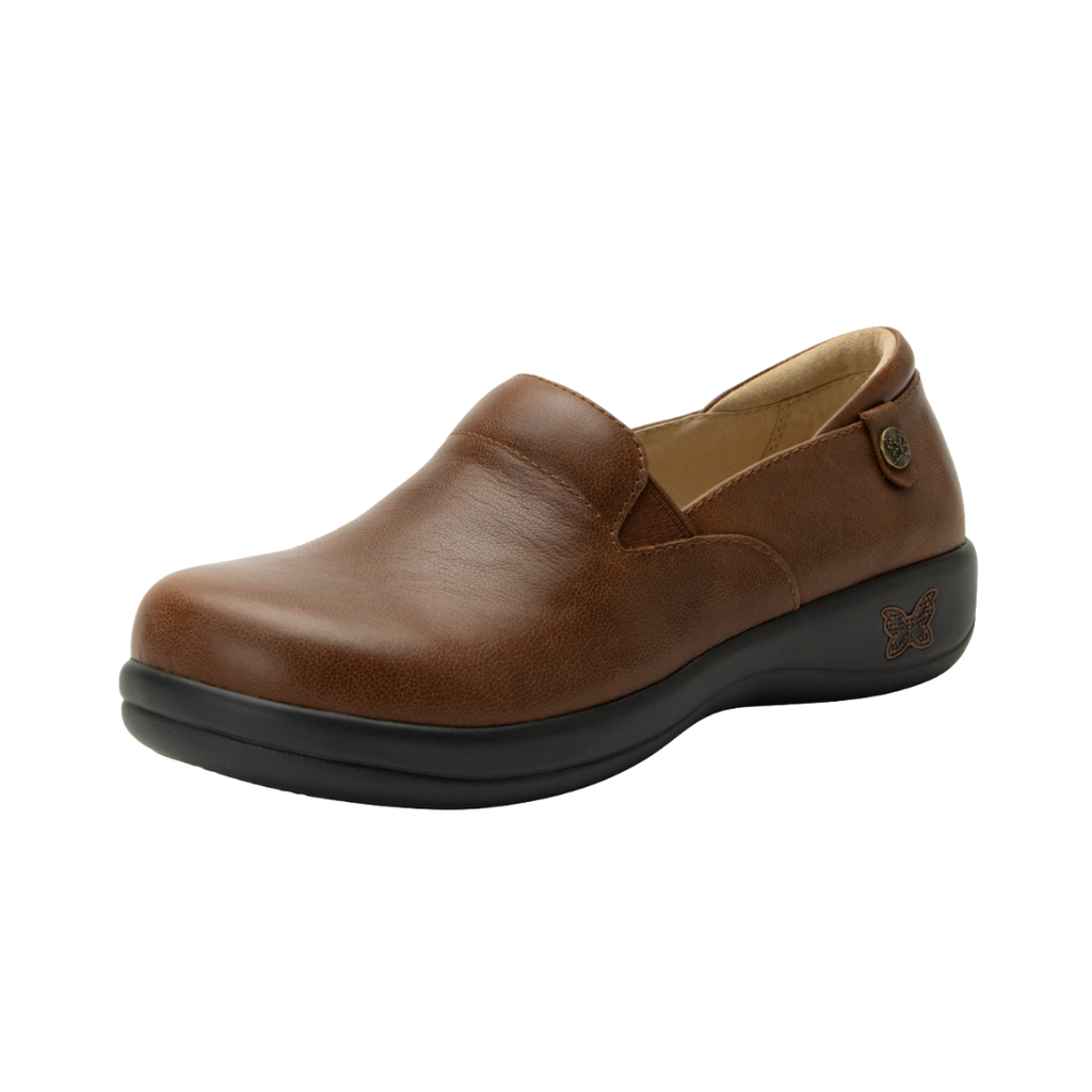 Alegria Women’s Keli Slip-On Shoe in Walnut side view showcasing the stain-resistant leather upper with a rich brown luster finish, professional slip-on silhouette, padded collar, mild rocker sole, and slip-resistant outsole designed for lasting comfort and workplace stability.