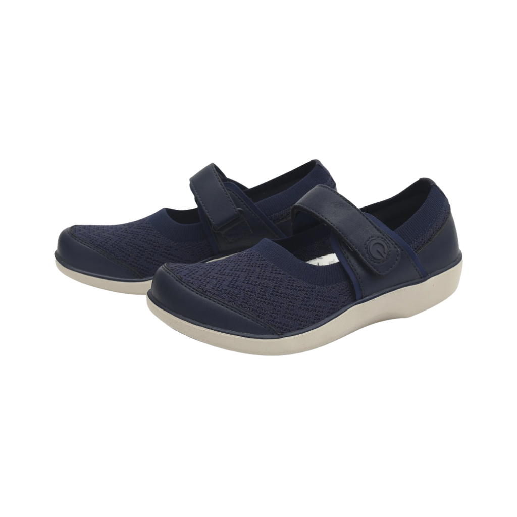 Alegria Women’s TRAQ Qutie Slip-On Shoe in Blue Multi side view showcasing the colorful Dream Fit® knitted textile upper, adjustable hook-and-loop strap, ribbed ankle collar, Q-Sport rocker outsole, and lightweight slip-resistant sole designed for all-day comfort and smart walking support.