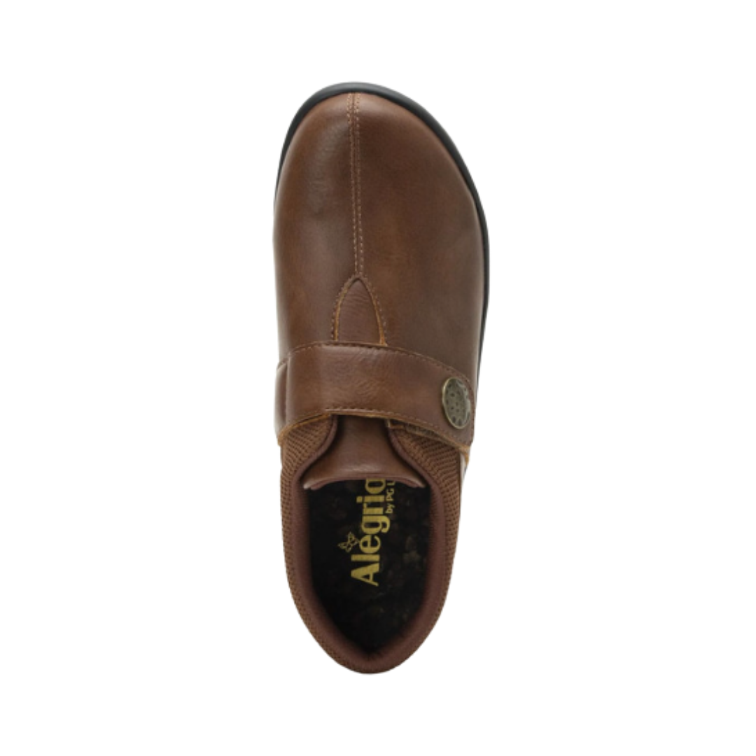 Alegria Women’s Danni Slip-On Shoe in Saddle top view showcasing the adjustable hook-and-loop closure, breathable textile lining, removable Alegria footbed, and cushioned interior featuring contoured cork, memory foam, and latex support.