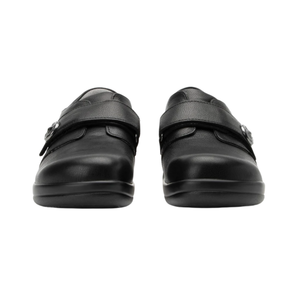 Alegria Women’s Joleen Slip-On Shoe in Upgrade Black front view highlighting the roomy rounded toe box, smooth leather upper, adjustable strap closure, and supportive silhouette designed to provide extra comfort for bunions, hammertoes, and sensitive forefoot areas.