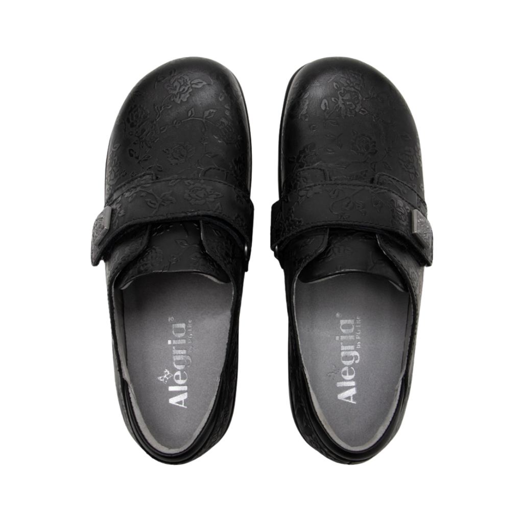 Alegria Women’s Joleen Slip-On Shoe in Class Act top view showcasing the premium leather upper, hook-and-loop strap with decorative button, spacious foot opening, soft lining, and removable Alegria footbed featuring cork, memory foam, and polyurethane cushioning.