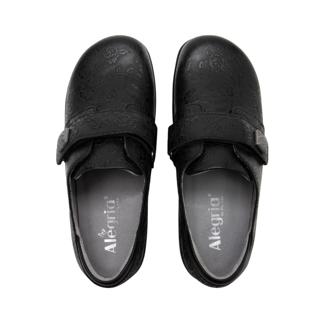 Alegria Women’s Joleen Slip-On Shoe in Class Act top view showcasing the premium leather upper, hook-and-loop strap with decorative button, spacious foot opening, soft lining, and removable Alegria footbed featuring cork, memory foam, and polyurethane cushioning.