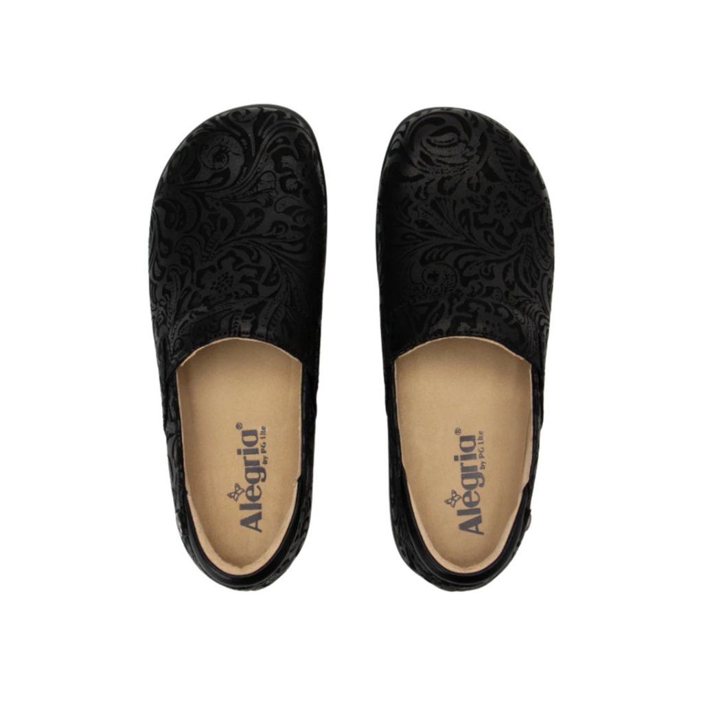 Alegria Women’s Keli Slip-On Shoe in Black Emboss Paisley top view showcasing the textured embossed leather upper, twin elastic goring for easy on and off, removable Alegria footbed with cork, memory foam, and latex cushioning, and a spacious interior for supportive wear.