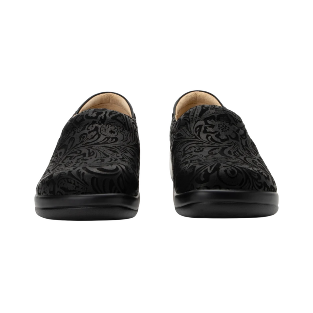 Alegria Women’s Keli Slip-On Shoe in Black Emboss Paisley front view highlighting the embossed leather upper, rounded roomy toe box, twin elastic gore panels, and polished slip-on design ideal for healthcare, culinary, and service professionals.