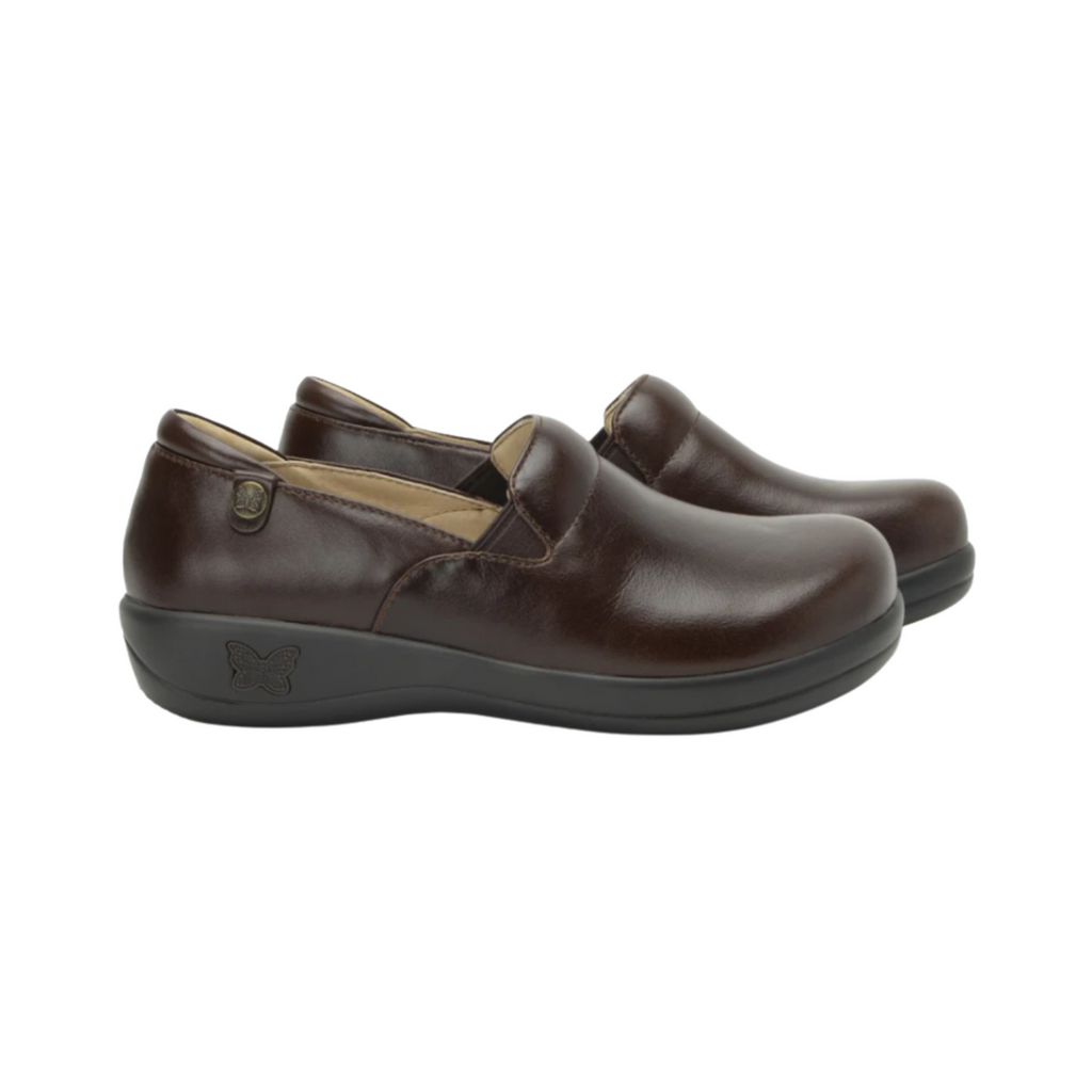Alegria Women’s Keli Slip-On Shoe in Choco Luster side view showcasing the stain-resistant leather upper with a rich brown luster finish, professional slip-on silhouette, padded collar, mild rocker sole, and slip-resistant outsole designed for lasting comfort and workplace stability.