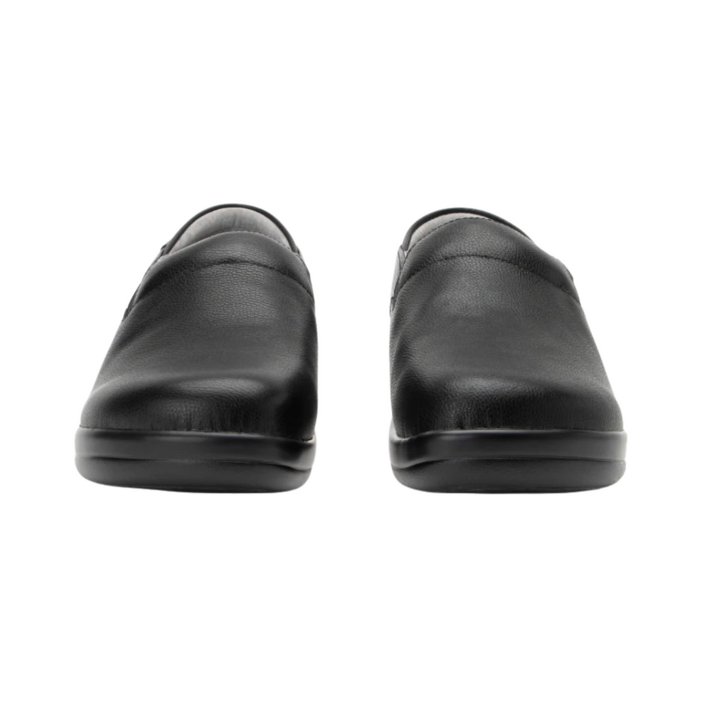 Alegria Women’s Keli Slip-On Shoe in Upgrade Black front view highlighting the embossed leather upper, rounded roomy toe box, twin elastic gore panels, and polished slip-on design ideal for healthcare, culinary, and service professionals.