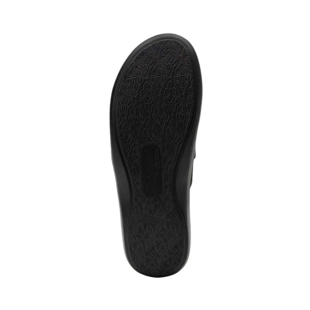 Alegria Women’s Savvie Slip-On Shoe in Black Smooth bottom view featuring the lightweight slip-resistant outsole with traction pattern designed to provide dependable grip, stability, and comfortable movement across a variety of surfaces.