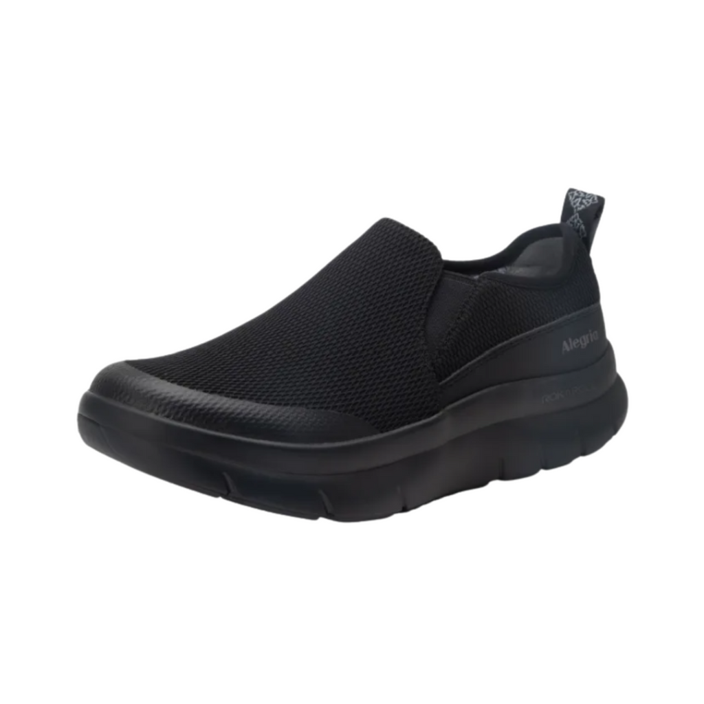 Alegria Women’s Shift Lead Slip-On Athletic Shoe in Black Mesh side view showcasing the breathable mesh upper, lightweight slip-on design, cushioned EVA midsole, padded interior, and slip-resistant rubber outsole built for all-day professional comfort and support.