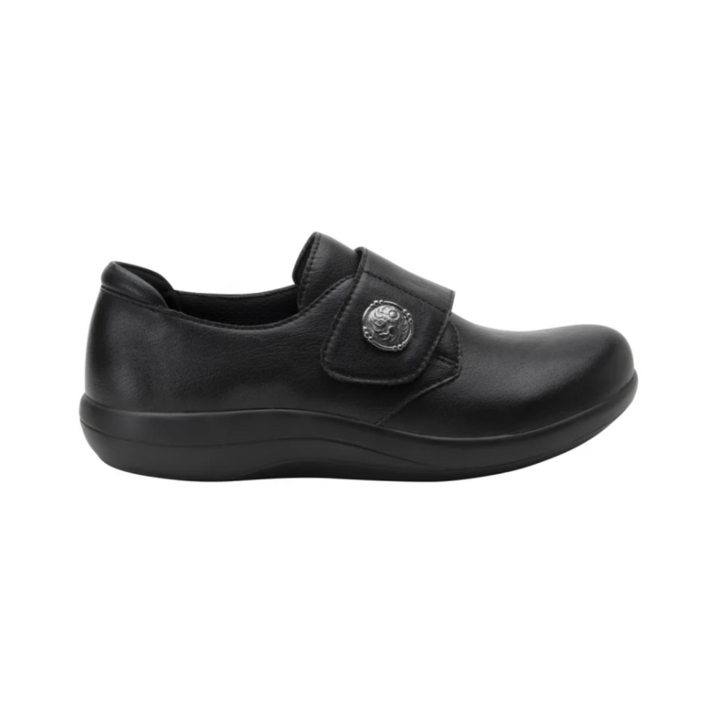Alegria Women’s Spright Slip-On Shoe in Black Smooth side view showcasing the premium smooth upper, Dream Fit® knit fabric panels, elastic stretch slip-on design, lightweight construction, mild rocker sole, and slip-resistant outsole for comfortable everyday support.