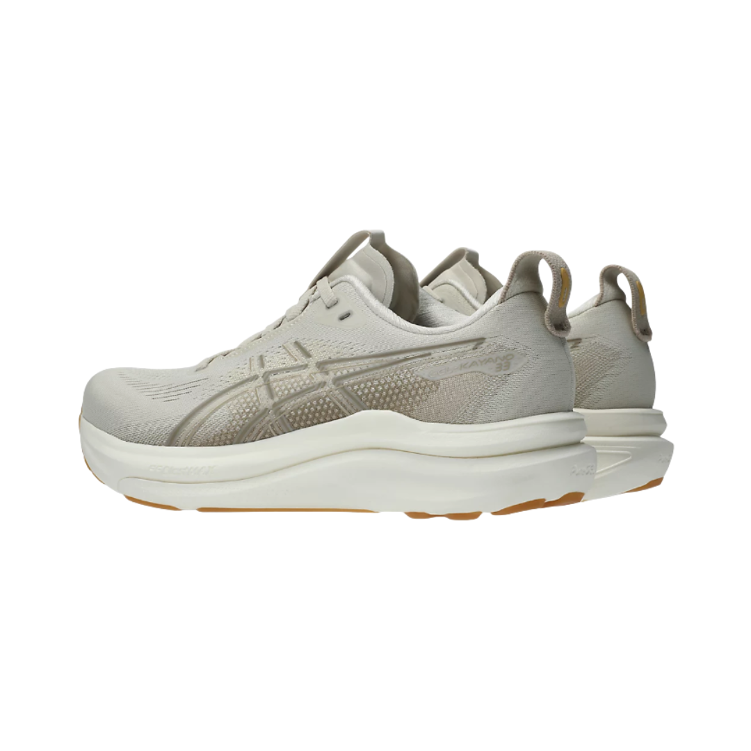 Heel view of the Women's ASICS Gel-Kayano 33 in Oatmeal/Cream, highlighting the supportive heel structure, rearfoot PureGEL™ technology for shock absorption, and reflective details for improved low-light visibility.