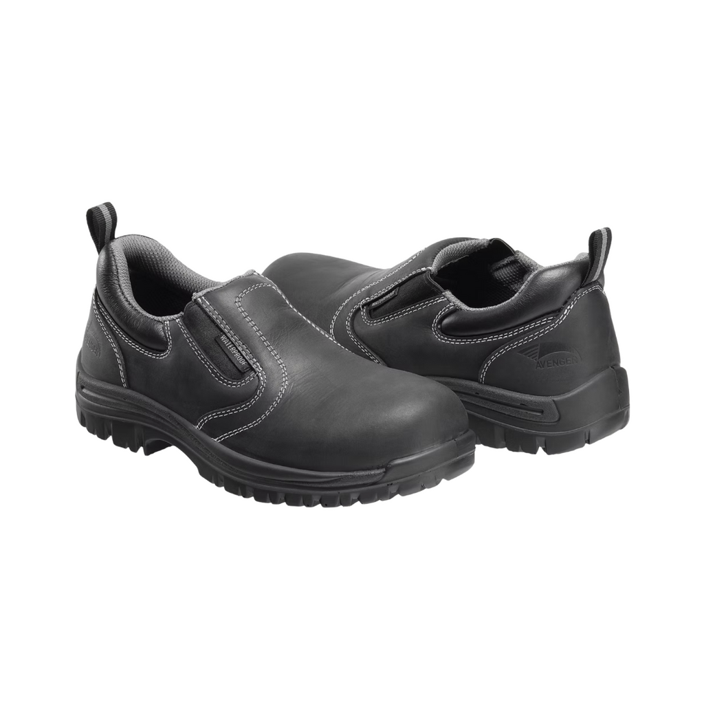 Side view of the Avenger Women’s Foreman Slip-On Composite Toe in Black featuring a sleek full-grain leather upper, convenient slip-on design with elastic gore panels, ASTM-rated composite safety toe, removable dual-density cushioned insole, and slip- & oil-resistant rubber outsole designed for professional work environments.
