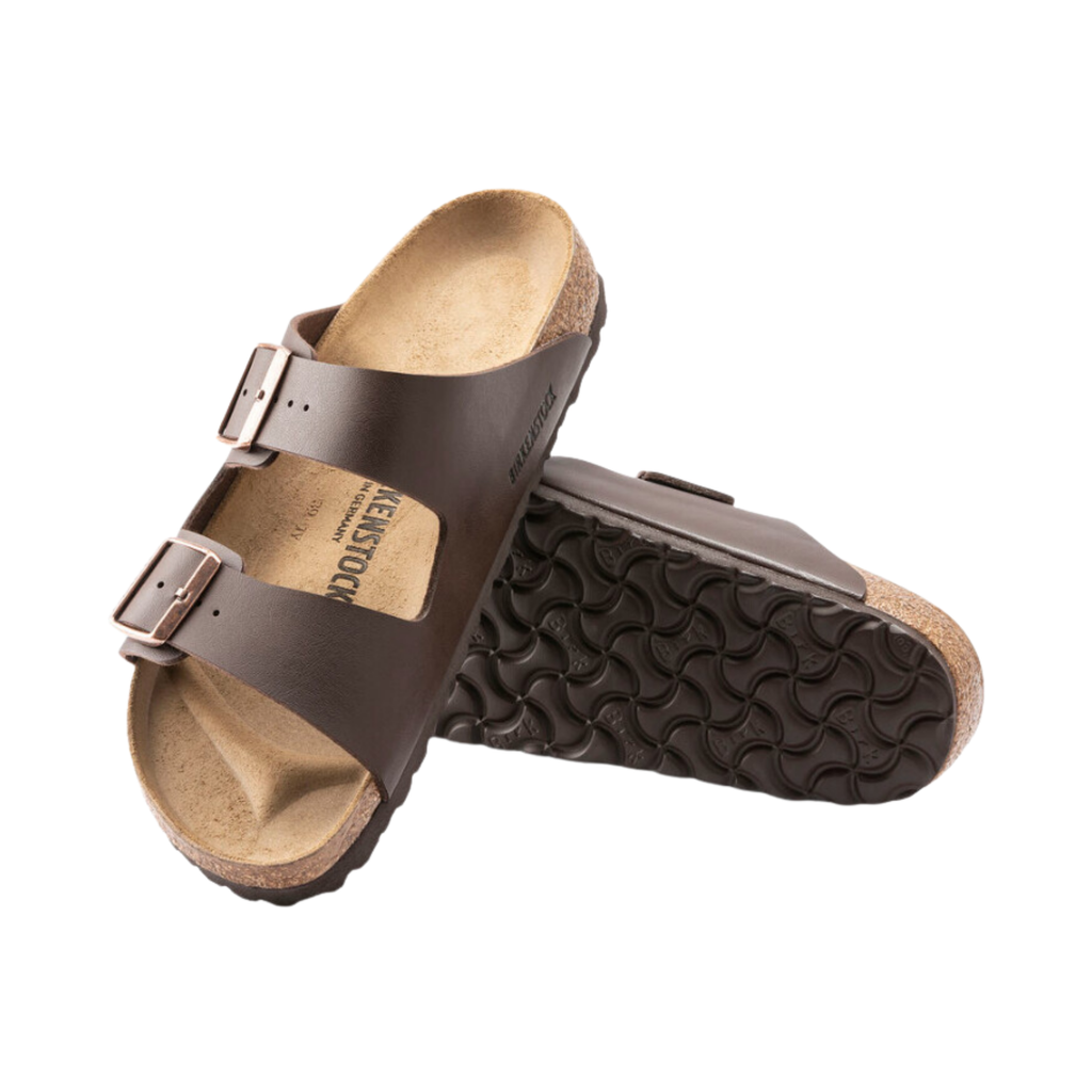 Top and bottom view of the Birkenstock Arizona in Dark Brown Birko-Flor displaying the smooth Birko-Flor upper, breathable suede footbed lining, adjustable dual buckle straps, anatomically shaped cork-latex footbed with arch and metatarsal support, and lightweight EVA outsole designed for flexibility, traction, and support for conditions such as plantar fasciitis, flat feet, heel spurs, heel pain, overpronation, metatarsalgia, and general foot fatigue.