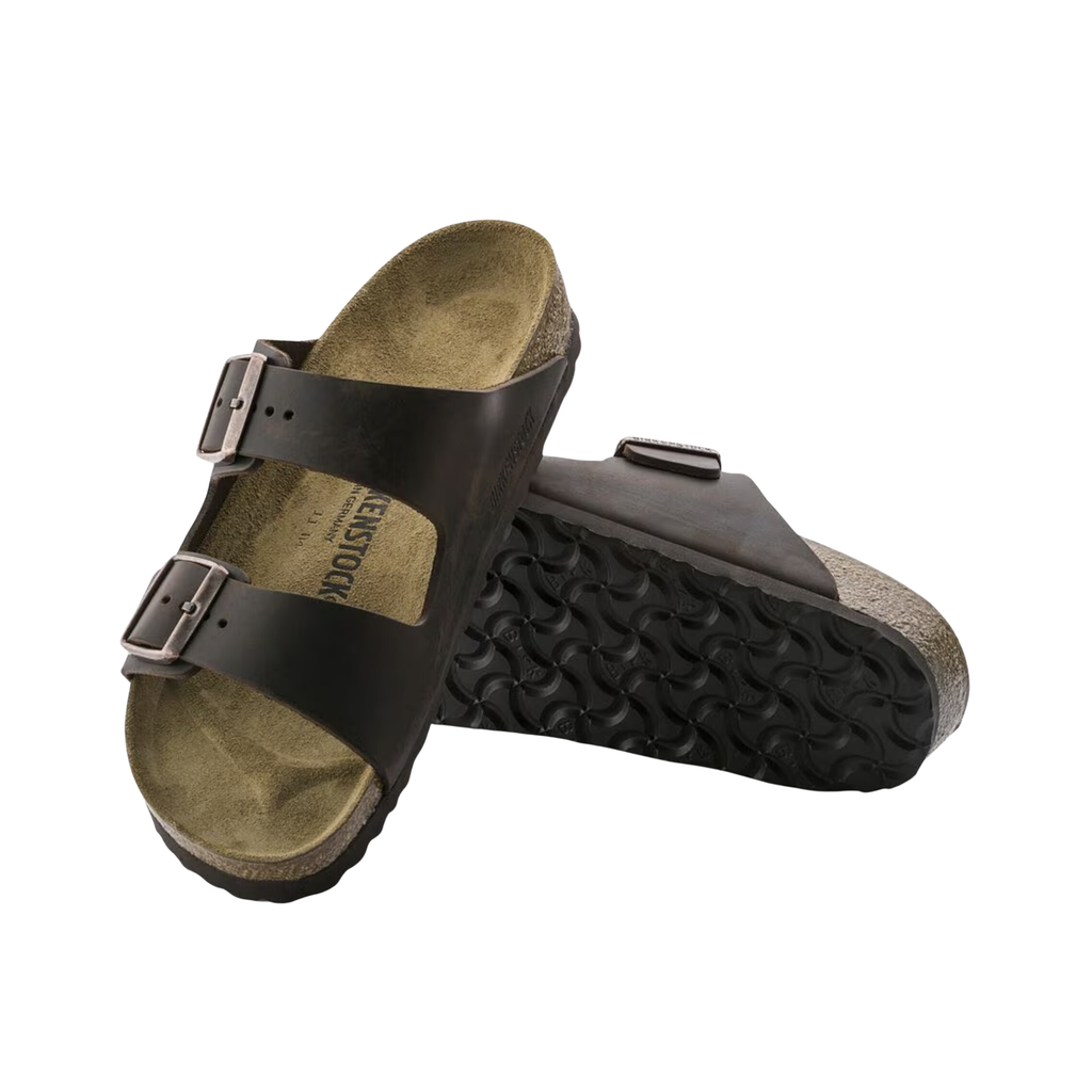Top and bottom view of the Birkenstock Men’s Arizona Soft Footbed in Habana Oiled Leather displaying the premium oiled leather upper, suede footbed lining, dual adjustable buckle straps, contoured cork-latex soft footbed with arch, heel, and metatarsal support, and lightweight EVA outsole designed for flexibility, traction, and support for conditions such as plantar fasciitis, flat feet, overpronation, metatarsalgia, heel spurs, bunions, sensitive toes, and general foot fatigue.