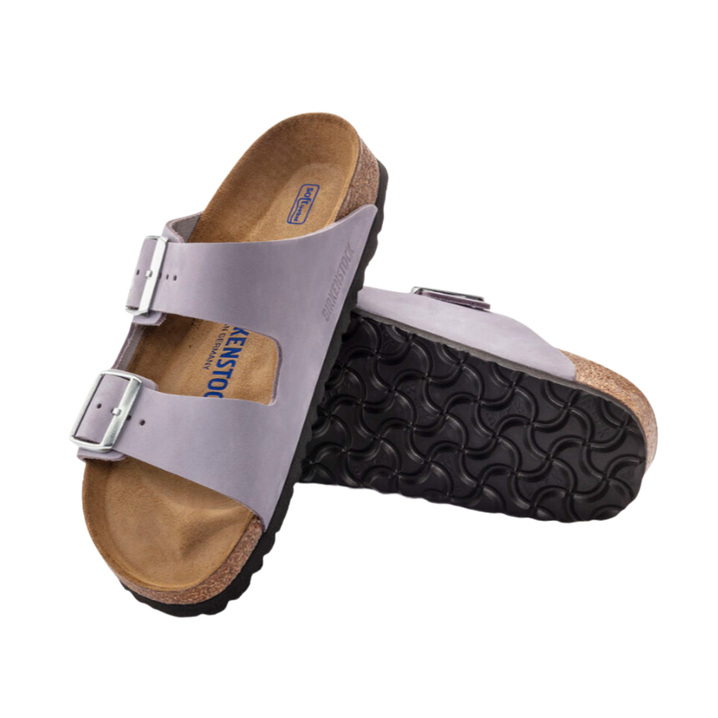 Top and bottom view of the Birkenstock Women’s Arizona Soft Footbed in Purple Fog Nubuck Leather displaying the premium nubuck leather upper, adjustable dual buckle straps, breathable suede footbed lining, anatomically shaped cork-latex Soft Footbed with arch and heel support, and lightweight EVA outsole designed for flexibility, traction, and support for conditions such as plantar fasciitis, flat feet, overpronation, metatarsalgia, heel spurs, arthritis, and general foot fatigue.