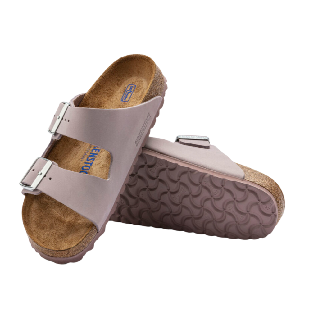 Top and bottom view of the Birkenstock Women’s Arizona Soft Footbed in Yomo Lilac Nubuck Leather displaying the premium nubuck leather upper, adjustable dual buckle straps, breathable suede footbed lining, anatomically shaped cork-latex Soft Footbed with arch and heel support, and lightweight EVA outsole designed for flexibility, traction, and support for conditions such as plantar fasciitis, flat feet, overpronation, metatarsalgia, heel spurs, arthritis, and general foot fatigue.