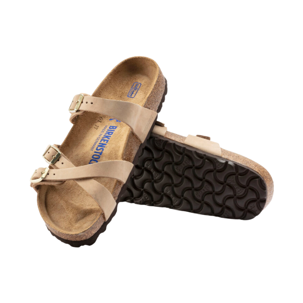 Top and bottom view of the Birkenstock Women’s Franca Soft Footbed in Sandcastle Nubuck Leather displaying the premium nubuck leather crisscross straps, adjustable metal buckles, breathable suede footbed lining, anatomically shaped cork-latex Soft Footbed with arch support and heel cushioning, and lightweight EVA outsole designed for flexibility, traction, and support for conditions such as plantar fasciitis, flat feet, metatarsalgia, overpronation, heel spurs, and general foot fatigue.