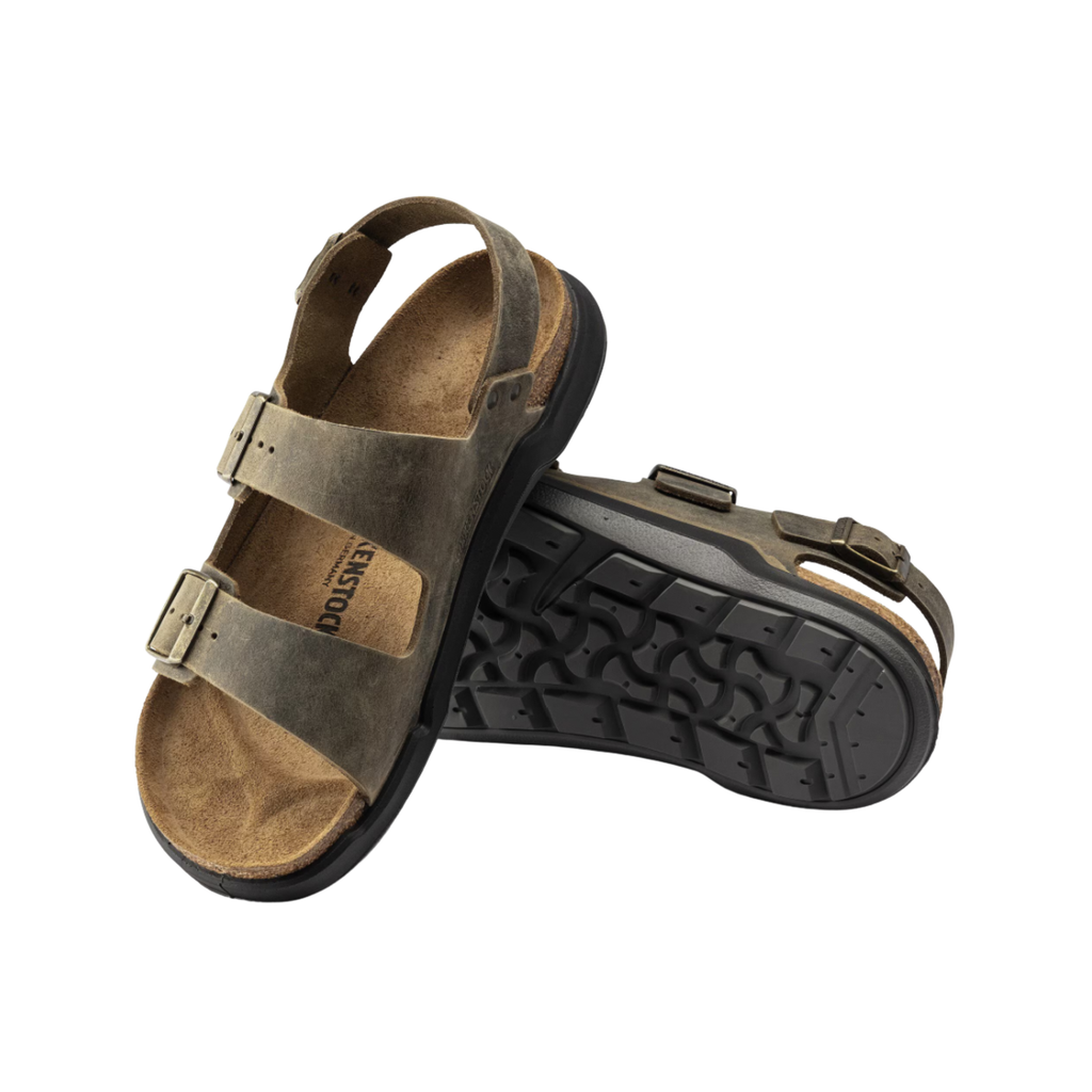 Top and bottom view of the Birkenstock Men’s Milano Rugged in Faded Khaki Oiled Leather displaying the breathable oiled leather upper, three-point adjustable strap system, raised toe bar, anatomically shaped cork-latex footbed with arch and heel support, and textured rugged EVA outsole designed for traction, flexibility, and support for conditions such as plantar fasciitis, flat feet, heel spurs, overpronation, metatarsalgia, bunions, and general foot fatigue.