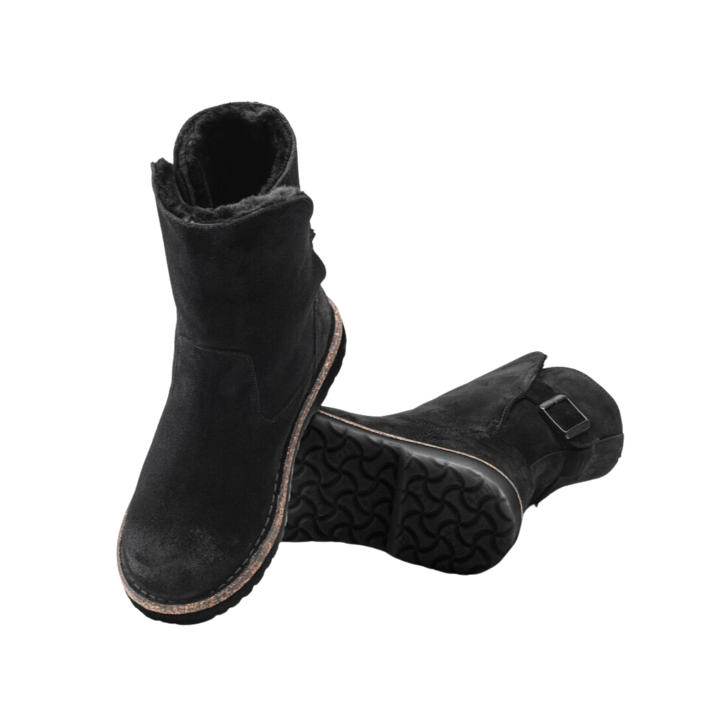 Top and bottom view of the Birkenstock Women’s Uppsala Shearling Boot in Black Suede displaying the soft suede leather upper, shearling-lined opening, cozy insulated interior, elastic side panels for easy slip-on wear, anatomically shaped cork-latex footbed with arch support and heel stabilization, and flexible rubber outsole with traction pattern designed for warmth, stability, shock absorption, and support for conditions such as plantar fasciitis, arthritis, flat feet, heel spurs, cold-sensitive feet, and