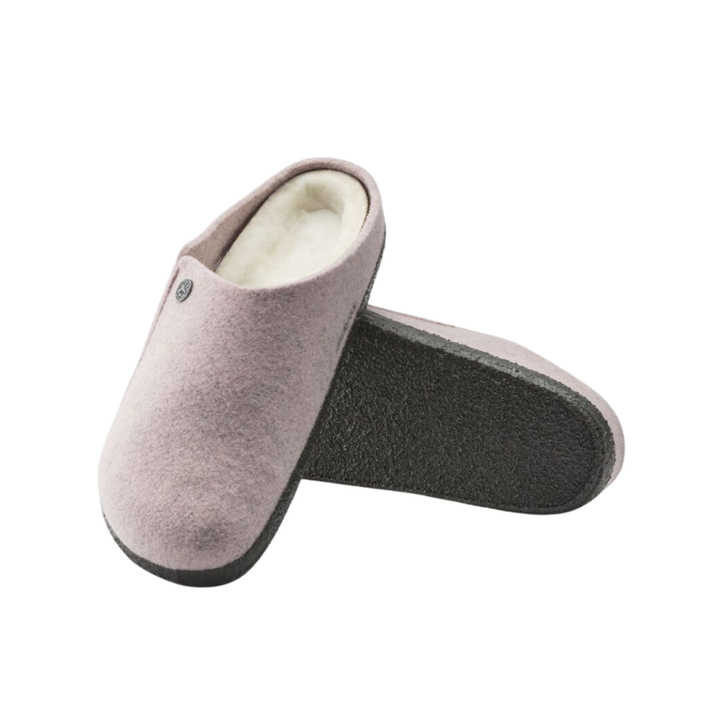 Top and bottom view of the Birkenstock Women’s Zermatt Shearling Slipper in Soft Pink Wool Felt displaying the premium wool felt upper, genuine shearling interior, easy slip-on entry, anatomical cork-latex footbed with arch and heel support, and durable rubber outsole designed for warmth, traction, flexibility, and support for conditions such as plantar fasciitis, arthritis, flat feet, high arches, heel spurs, cold sensitivity, bunions, hammertoes, and general foot fatigue.