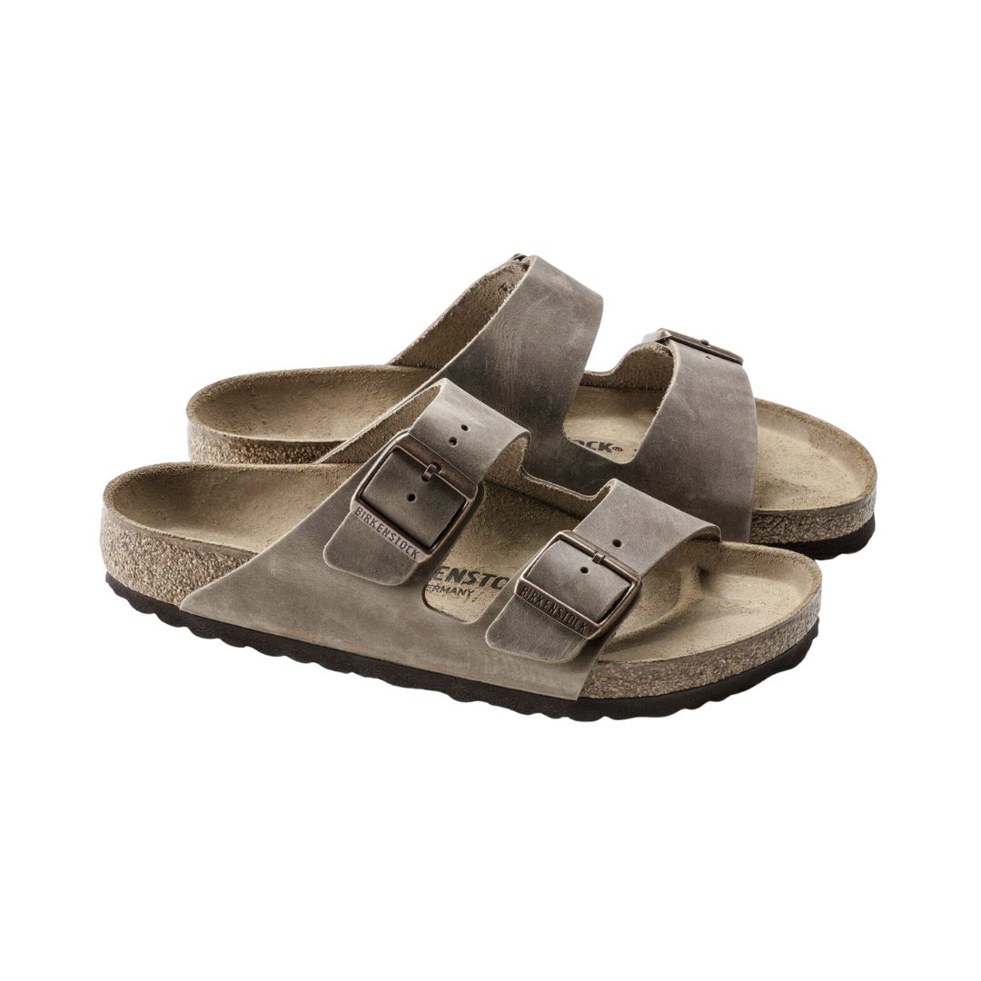 Side view of the Birkenstock Unisex Arizona Soft Footbed in Tobacco Brown Oiled Leather, showing the classic two-strap design, durable oiled leather upper, and contoured cork-latex footbed for supportive everyday comfort.
