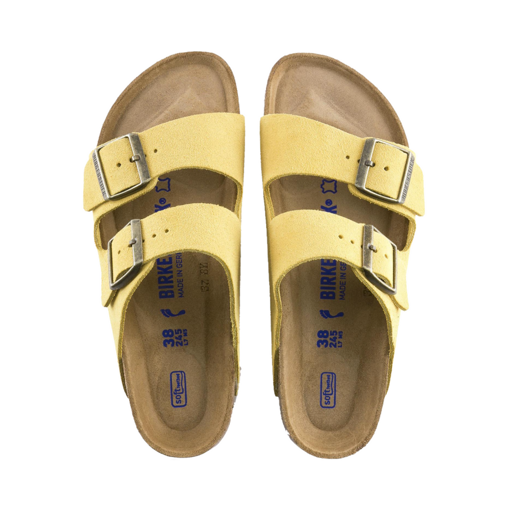 Top view of the Birkenstock Arizona Soft Footbed in Ochre Suede Leather displaying the premium suede leather upper, adjustable dual buckle straps, breathable suede footbed lining, anatomically shaped cork-latex Soft Footbed with arch and heel support, and lightweight EVA outsole designed for flexibility, traction, and support for conditions such as plantar fasciitis, flat feet, metatarsalgia, heel spurs, overpronation, and general foot fatigue.