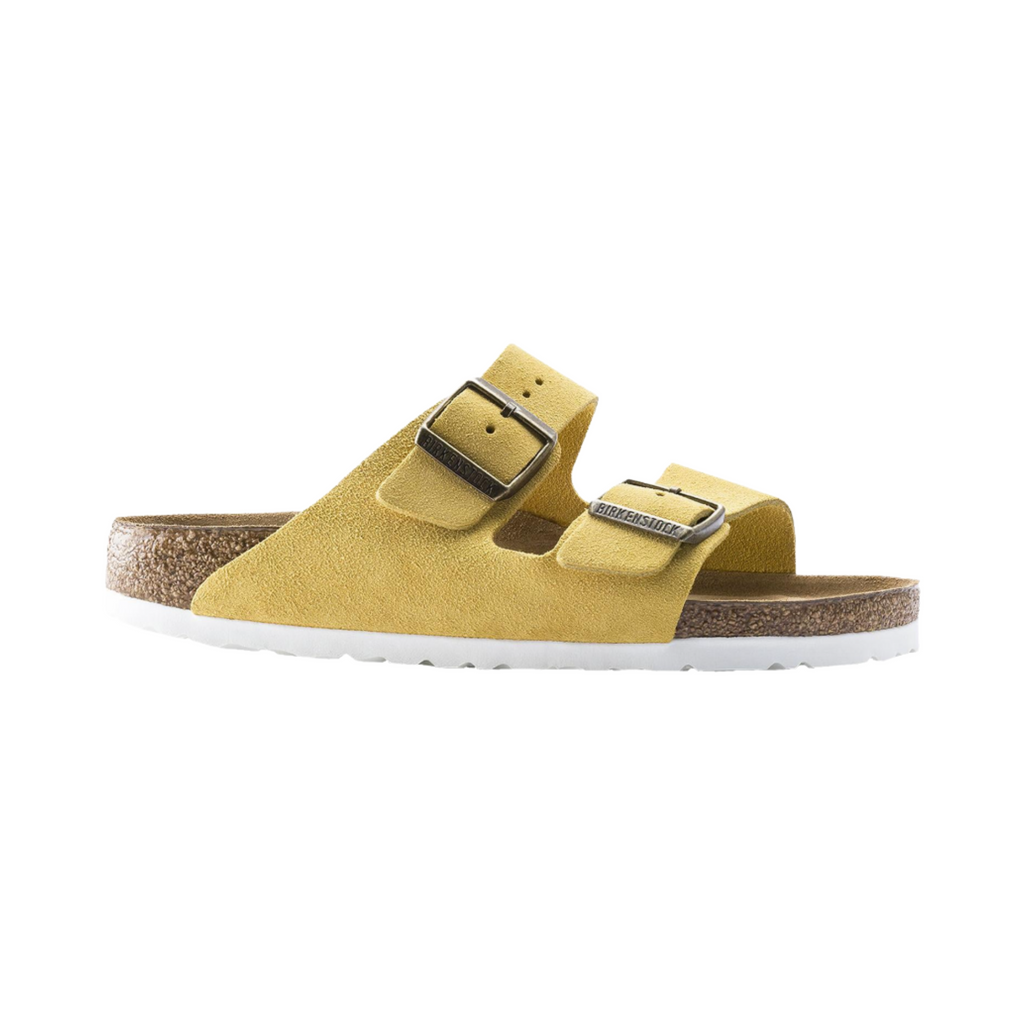 Birkenstock Arizona Soft Footbed in Ochre Suede Leather featuring a premium suede leather upper in a vibrant yellow-gold color, iconic dual-strap design with adjustable metal buckles, cushioned Soft Footbed with an added foam layer, anatomically shaped cork-latex footbed, and lightweight EVA outsole designed for bold style, lasting comfort, and everyday support.