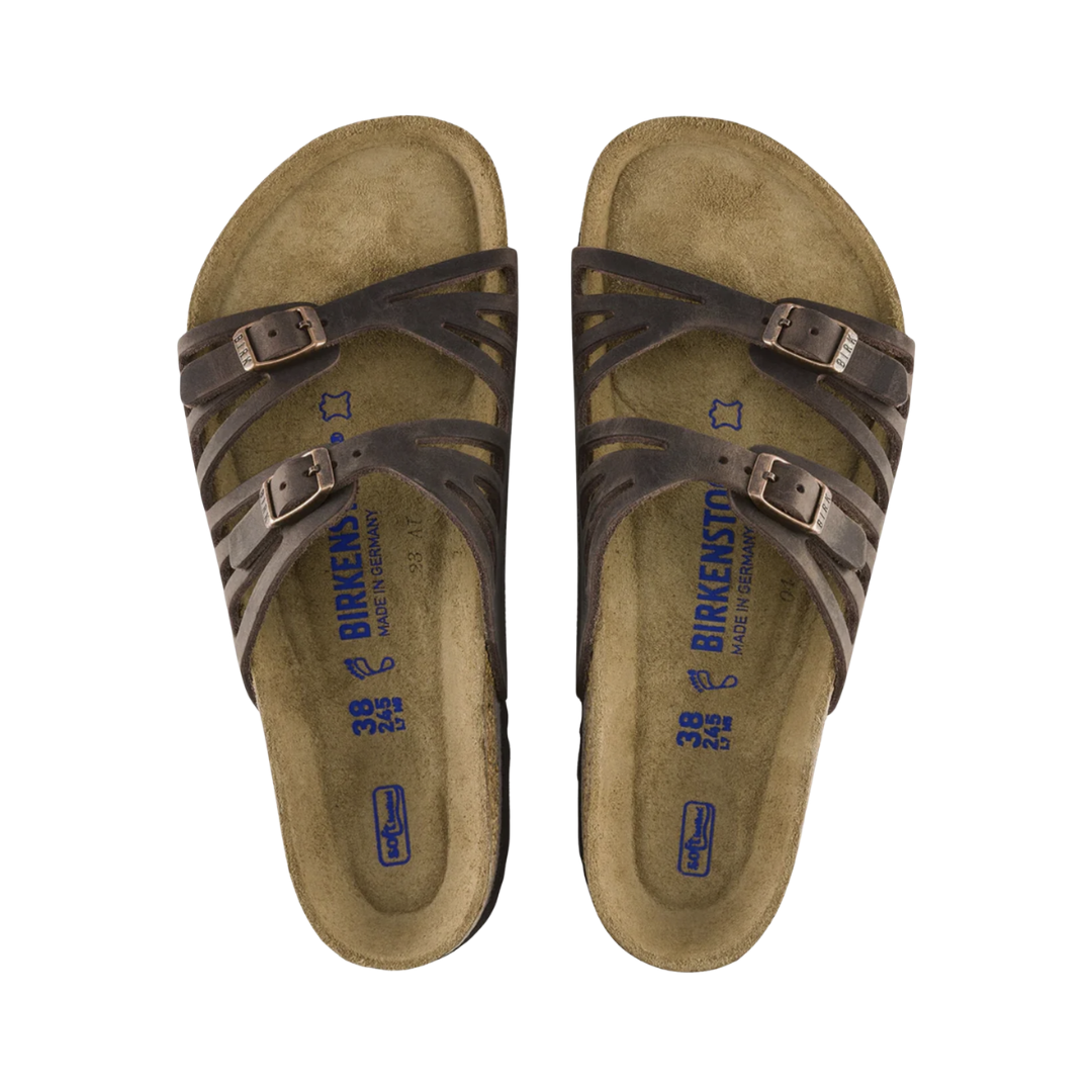 Top and bottom view of the Birkenstock Women’s Granada Soft Footbed in Habana Oiled Leather displaying the premium oiled leather upper, adjustable multi-strap buckle design, cushioned Soft Footbed with breathable lining, anatomically shaped cork-latex footbed with arch support, deep heel cup, and toe grip, along with the lightweight EVA outsole designed for flexibility, traction, and support for conditions such as plantar fasciitis, flat feet, overpronation, metatarsalgia, bunions, hammertoes, and ge