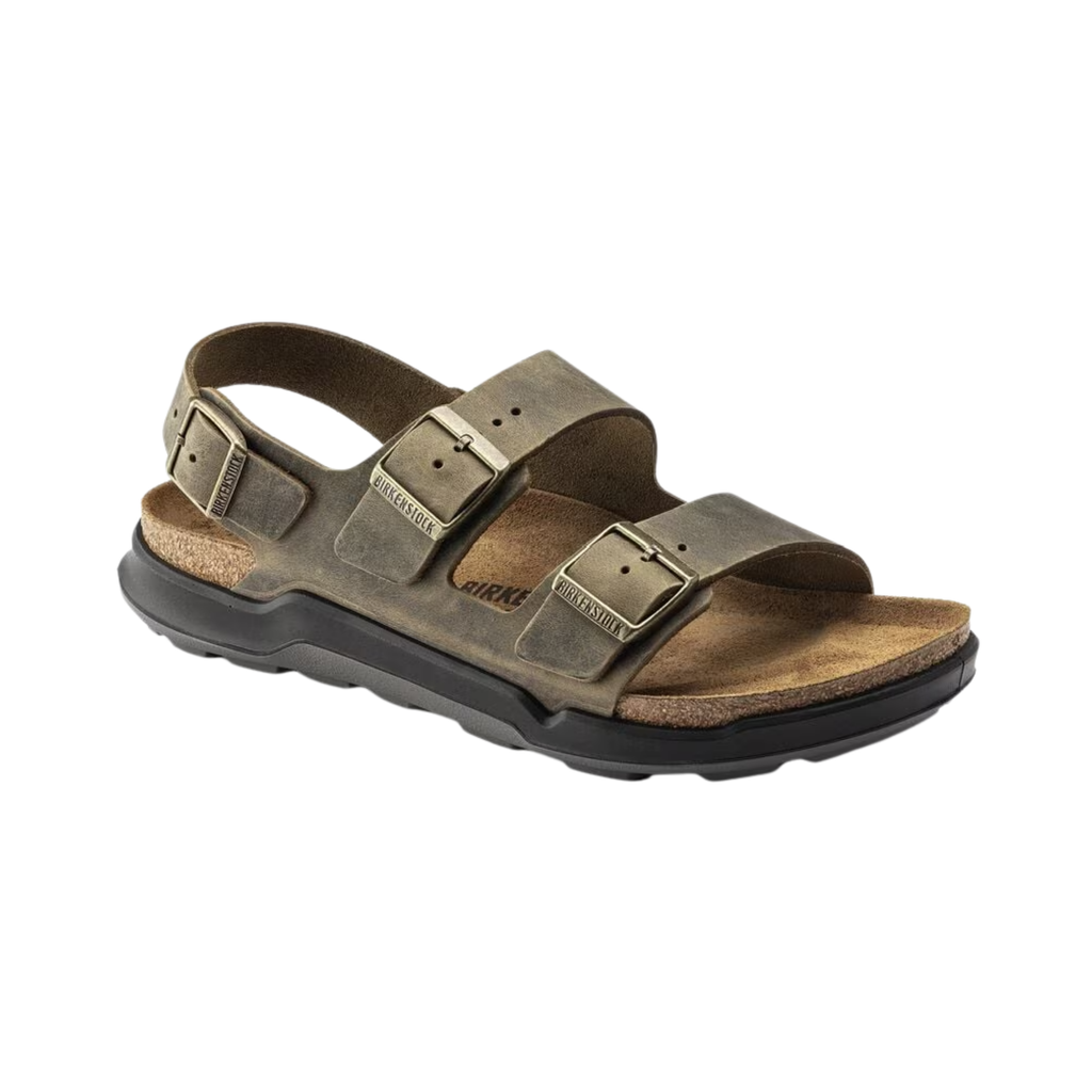Birkenstock Men’s Milano Rugged in Faded Khaki Oiled Leather featuring a durable oiled leather upper, three-strap design with adjustable metal pin buckles, supportive backstrap, anatomically shaped cork-latex footbed, and rugged EVA outsole designed for stability, comfort, and reliable performance during active wear.