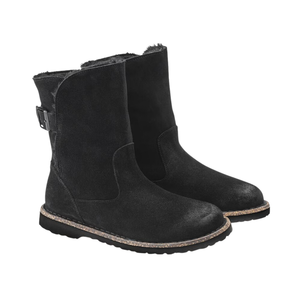 Birkenstock Women’s Uppsala Shearling Boot in Black Suede featuring a premium suede leather upper, mid-rise boot silhouette, elastic side panels for easy entry, genuine shearling lining, anatomically shaped cork-latex footbed, and flexible rubber outsole designed for winter comfort, warmth, and everyday support.