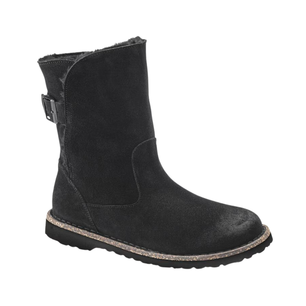 Birkenstock Women’s Uppsala Shearling Boot in Black Suede featuring a premium suede leather upper, mid-rise boot silhouette, elastic side panels for easy entry, genuine shearling lining, anatomically shaped cork-latex footbed, and flexible rubber outsole designed for winter comfort, warmth, and everyday support.
