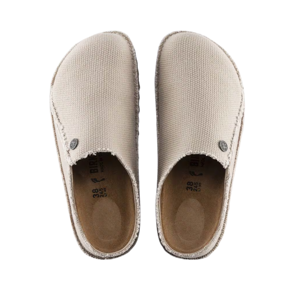 Top view of the Birkenstock Women’s Zermatt Canvas Slipper in Eggshell Textile displaying the breathable textile upper, moisture-wicking interior lining, easy slip-on entry, anatomical cork-latex footbed with arch and heel support, and durable rubber outsole designed for traction, flexibility, and support for conditions such as plantar fasciitis, flat feet, high arches, arthritis, heel spurs, bunions, hammertoes, cold sensitivity, and general foot fatigue.