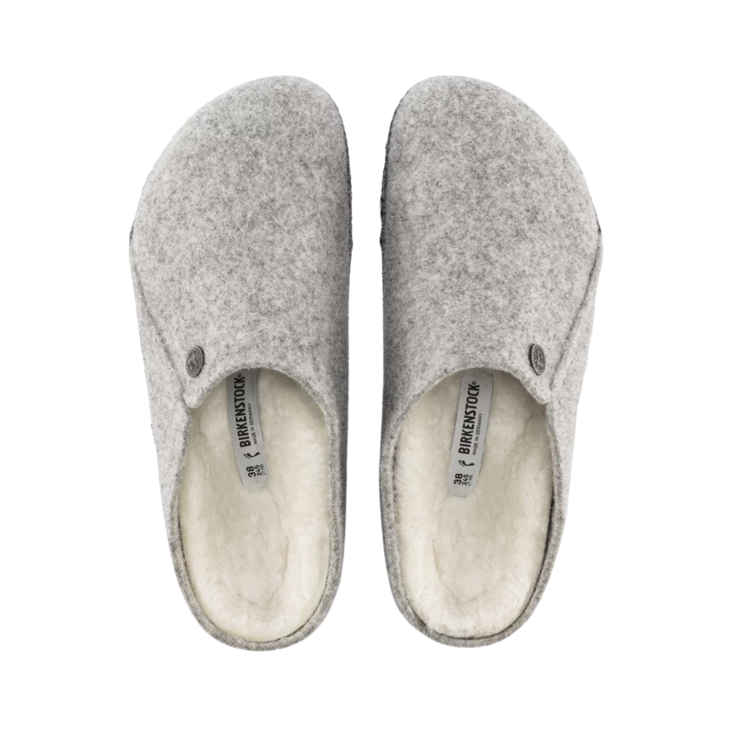 Top view of the Birkenstock Men’s Zermatt Shearling Slipper in Light Gray Wool Felt displaying the premium wool felt upper, genuine shearling interior, easy slip-on entry, anatomical cork-latex footbed with arch and heel support, and durable rubber outsole designed for warmth, traction, flexibility, and support for conditions such as plantar fasciitis, arthritis, flat feet, high arches, heel spurs, cold sensitivity, bunions, hammertoes, and general foot fatigue.