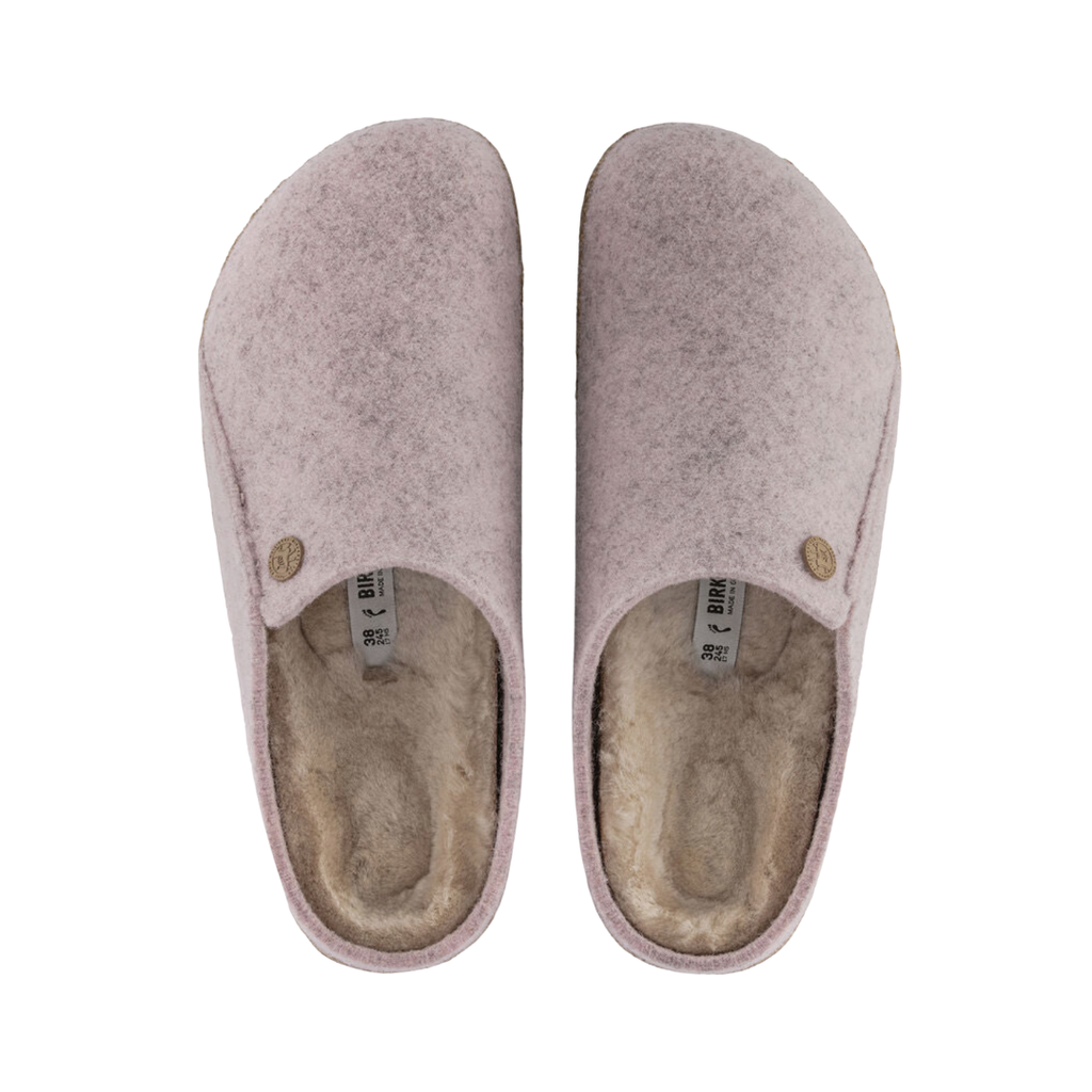 Top view of the Birkenstock Women’s Zermatt Shearling Slipper in Soft Pink Wool Felt displaying the premium wool felt upper, genuine shearling interior, easy slip-on entry, anatomical cork-latex footbed with arch and heel support, and durable rubber outsole designed for warmth, traction, flexibility, and support for conditions such as plantar fasciitis, arthritis, flat feet, high arches, heel spurs, cold sensitivity, bunions, hammertoes, and general foot fatigue.