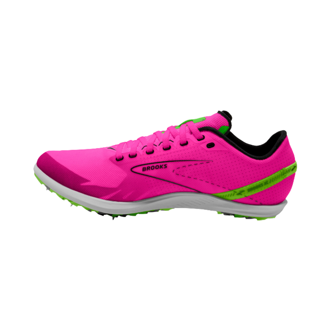 Brooks Women’s Draft XC Spike in Pink Glo/Green/Black featuring a lightweight breathable mesh upper, bold cross-country racing silhouette, cushioned EVA midsole, aggressive spike plate, and durable rubber lug outsole designed for speed, traction, and performance across dirt, grass, and gravel courses.