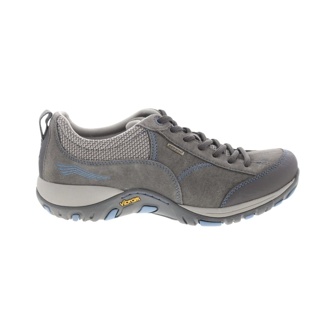 Dansko Women’s Paisley Suede Shoe in Grey/Blue featuring a waterproof suede upper, low-profile hiking-inspired silhouette, seam-sealed construction, Dansko Natural Arch® technology, removable triple-density EVA footbed, shock-absorbing midsole, Vibram® rubber outsole, and durable design built for all-day comfort, stability, and outdoor performance.