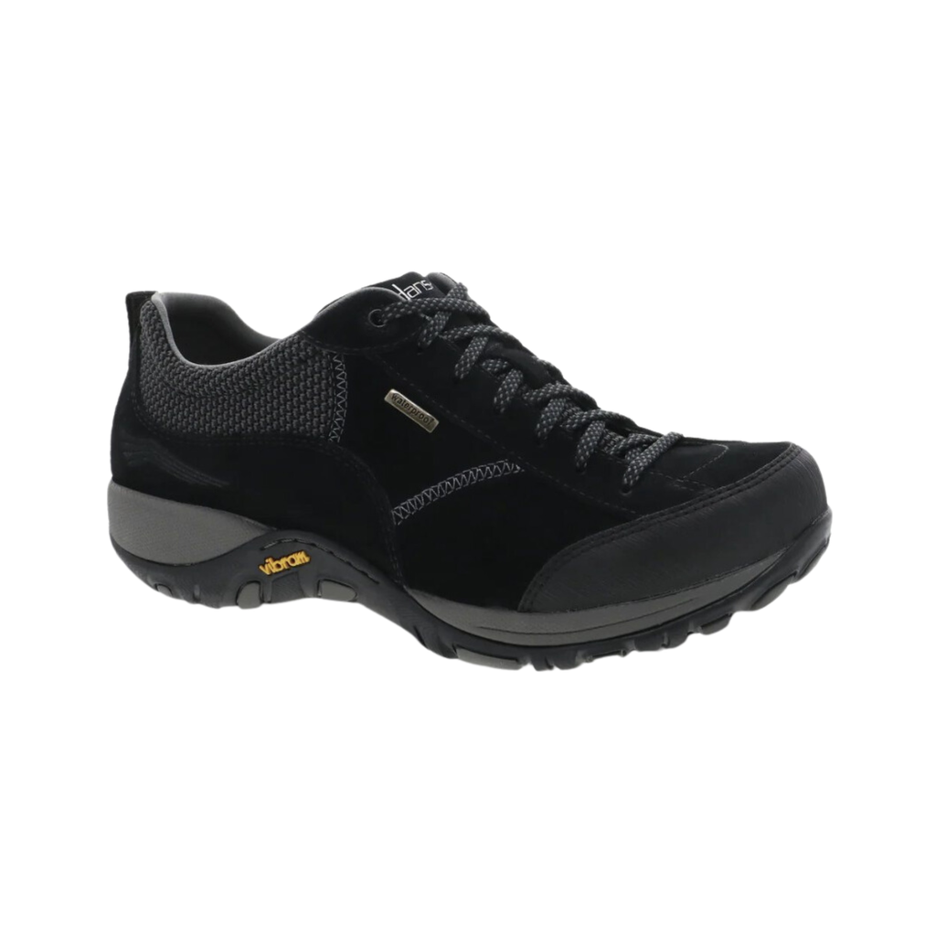 Dansko Women’s Paisley Suede Shoe in Black featuring a waterproof suede upper, low-profile hiking-inspired silhouette, seam-sealed construction, Dansko Natural Arch® technology, removable triple-density EVA footbed, shock-absorbing midsole, Vibram® rubber outsole, and durable design built for all-day comfort, stability, and outdoor performance.