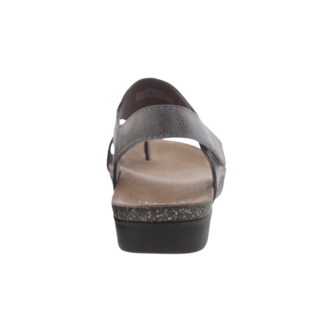 Back heel view of the Dansko Women’s Reece Sandal in Stone Waxy highlighting the adjustable heel strap, supportive heel cup, molded EVA footbed, lightweight construction, and durable rubber outsole designed to improve stability, reduce fatigue, and provide lasting comfort throughout the day.