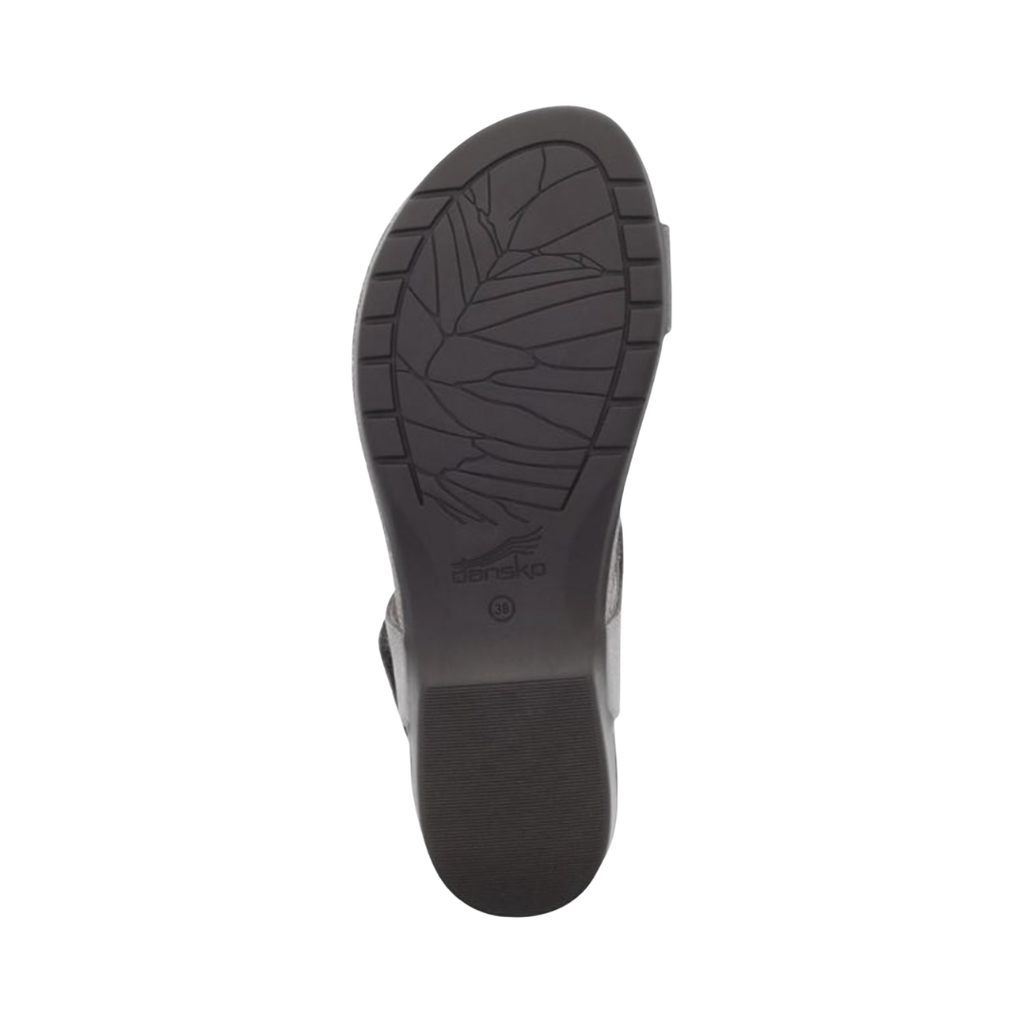 Bottom outsole view of the Dansko Women’s Reece Sandal in Stone Waxy featuring the lightweight rubber outsole engineered to provide dependable traction and flexibility on a variety of everyday surfaces while the molded EVA footbed and Dansko Natural Arch® technology help provide comfort for conditions such as plantar fasciitis, flat feet, heel pain, overpronation, and general foot fatigue.