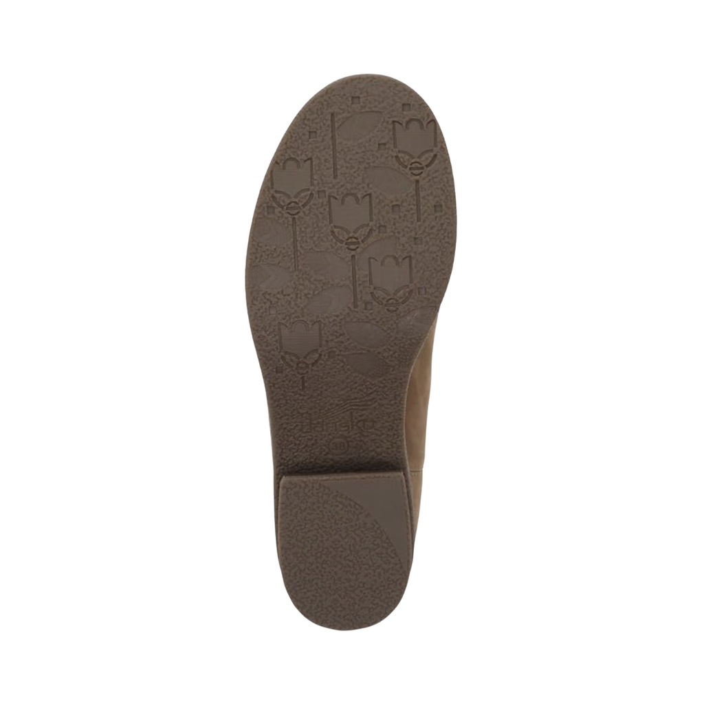 Bottom outsole view of the Dansko Women’s Bea Ankle Boot in Biscotti featuring the crepe-textured TR rubber outsole engineered to provide reliable traction, flexibility, and stability on a variety of surfaces while the removable cushioned footbed and Dansko Natural Arch® technology help provide comfort for conditions such as plantar fasciitis, heel pain, arch discomfort, metatarsalgia, high arches, flat feet, Achilles discomfort, joint stress, and general foot fatigue.