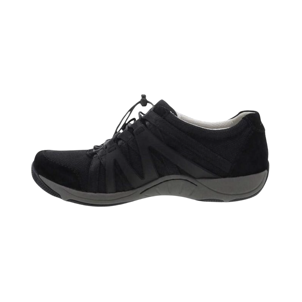 Dansko Women’s Henriette Suede Shoe in Black featuring a premium suede and recycled mesh upper, sporty low-top silhouette, adjustable bungee laces, removable EVA footbed, Strobel construction, natural rubber outsole, and lightweight design built for breathable comfort, flexibility, and all-day support.