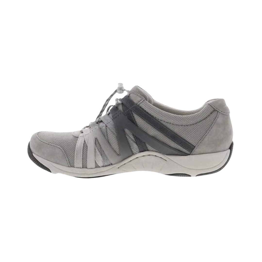 Dansko Women’s Henriette Suede Shoe in Grey featuring a premium suede and recycled mesh upper, sporty low-top silhouette, adjustable bungee laces, removable EVA footbed, Strobel construction, natural rubber outsole, and lightweight design built for breathable comfort, flexibility, and all-day support.
