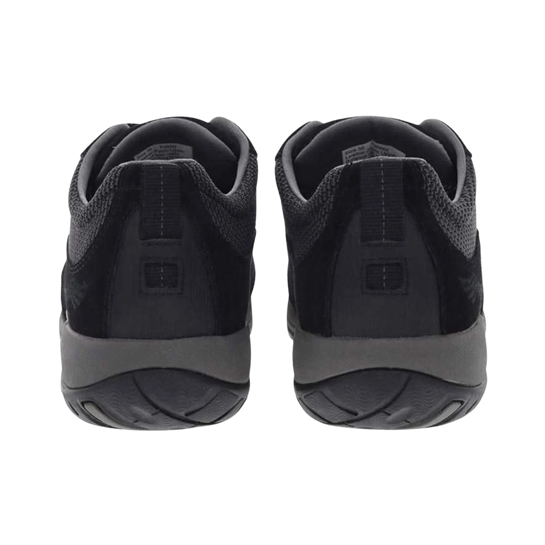 Back heel view of the Dansko Women’s Paisley Suede Shoe in Black highlighting the reinforced heel counter, supportive heel collar, TPU shank with Dansko Natural Arch® technology, shock-absorbing midsole, and durable Vibram® outsole designed to improve stability, reduce fatigue, and provide confident traction on varied terrain.