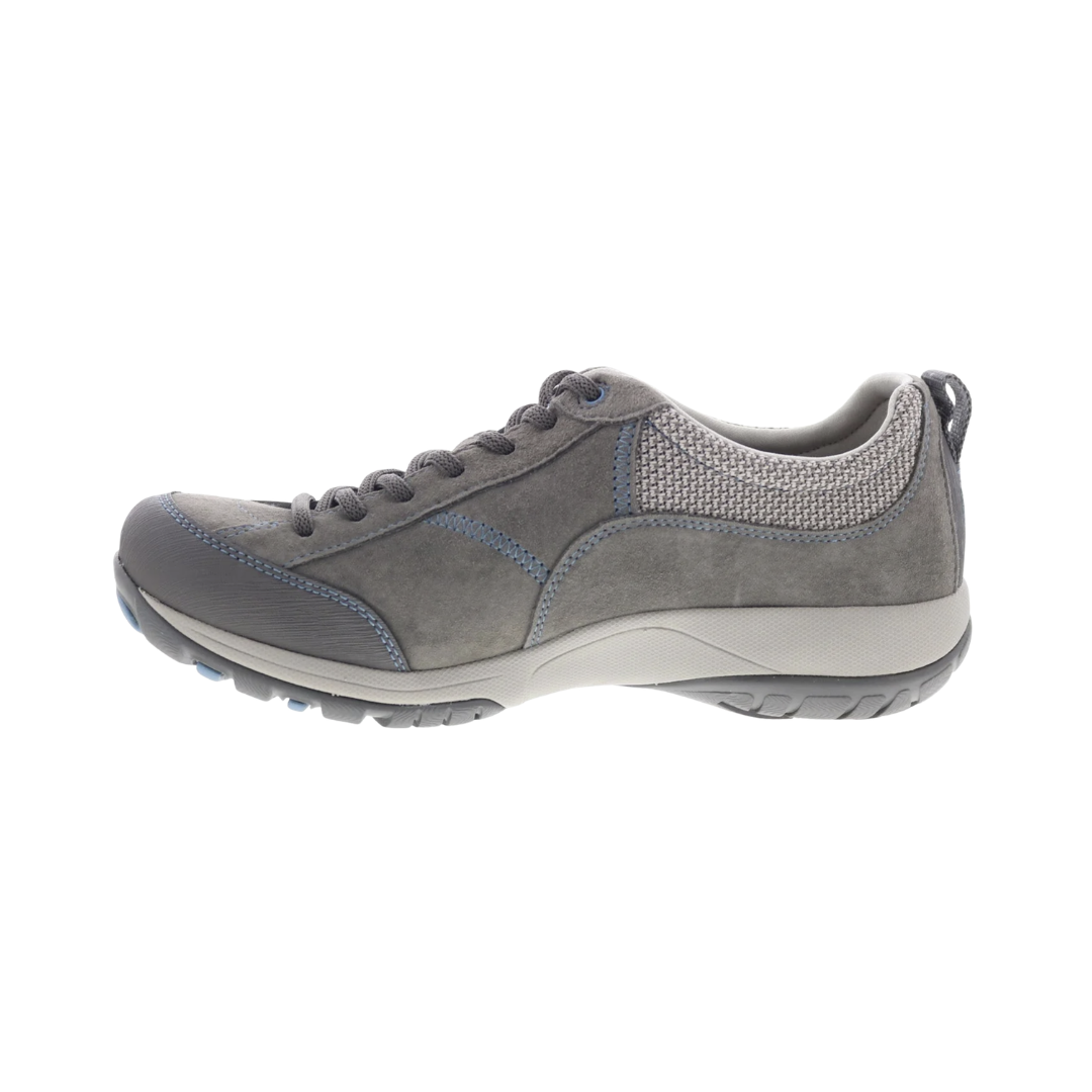Dansko Women’s Paisley Suede Shoe in Grey/Blue featuring a waterproof suede upper, low-profile hiking-inspired silhouette, seam-sealed construction, Dansko Natural Arch® technology, removable triple-density EVA footbed, shock-absorbing midsole, Vibram® rubber outsole, and durable design built for all-day comfort, stability, and outdoor performance.