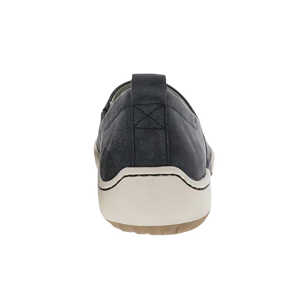 Back heel view of the Dansko Women’s Reba Vintage Slip-On Shoe in Black highlighting the reinforced heel counter, cushioned heel area, Dansko Natural Arch™ technology, lightweight EVA midsole, and durable outsole designed to improve stability, reduce fatigue, and provide dependable support throughout the day.